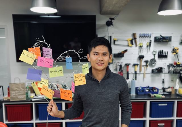 At a maker workshop with a sticky-note tree